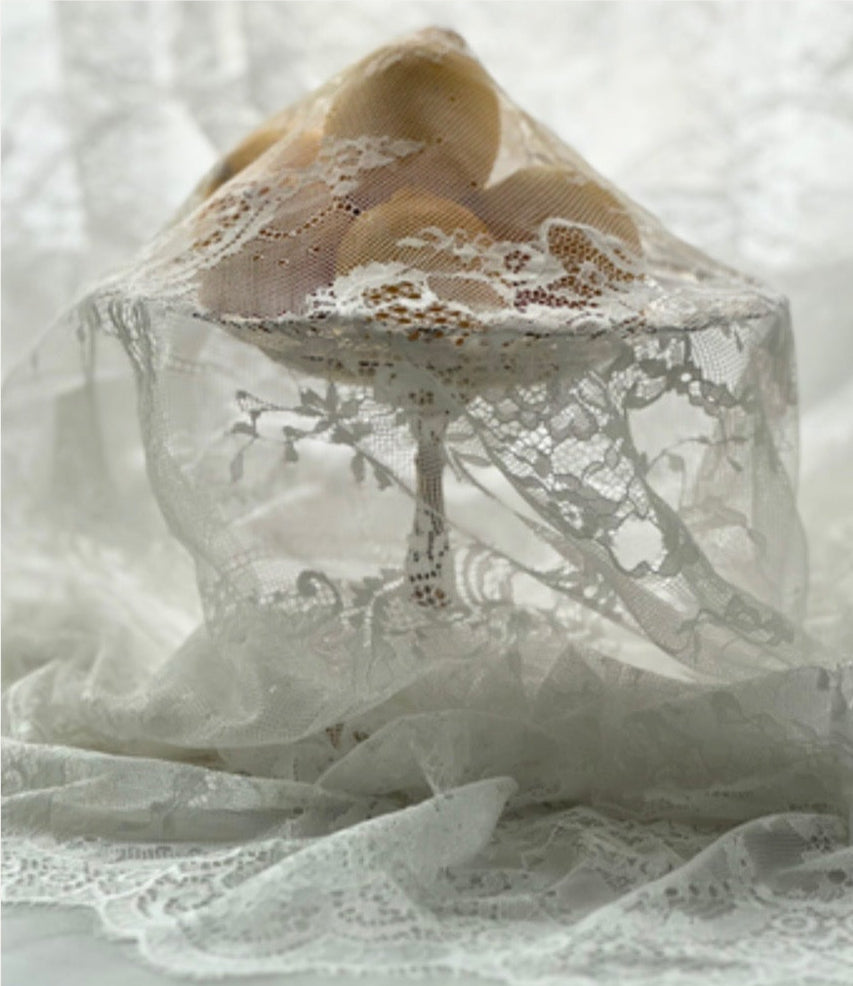 Lace fabric draped over a neutral background